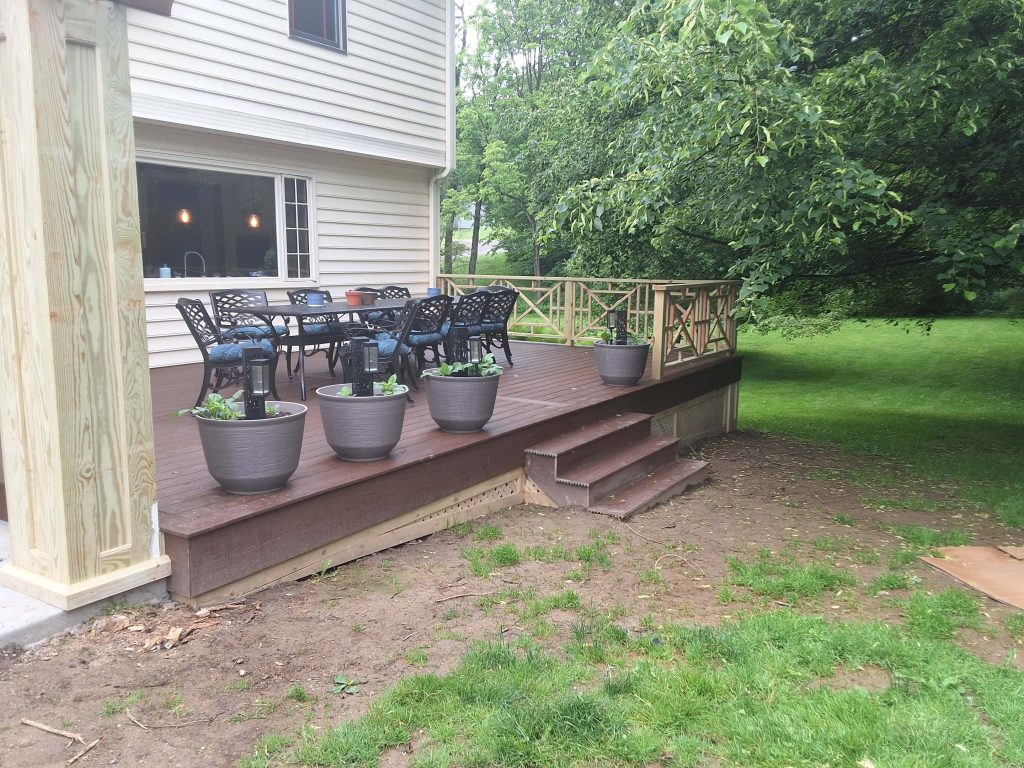 D Miller Exteriors Apple Creek OH builds brown composite deck with cross-rail cedar balustrade and planters.