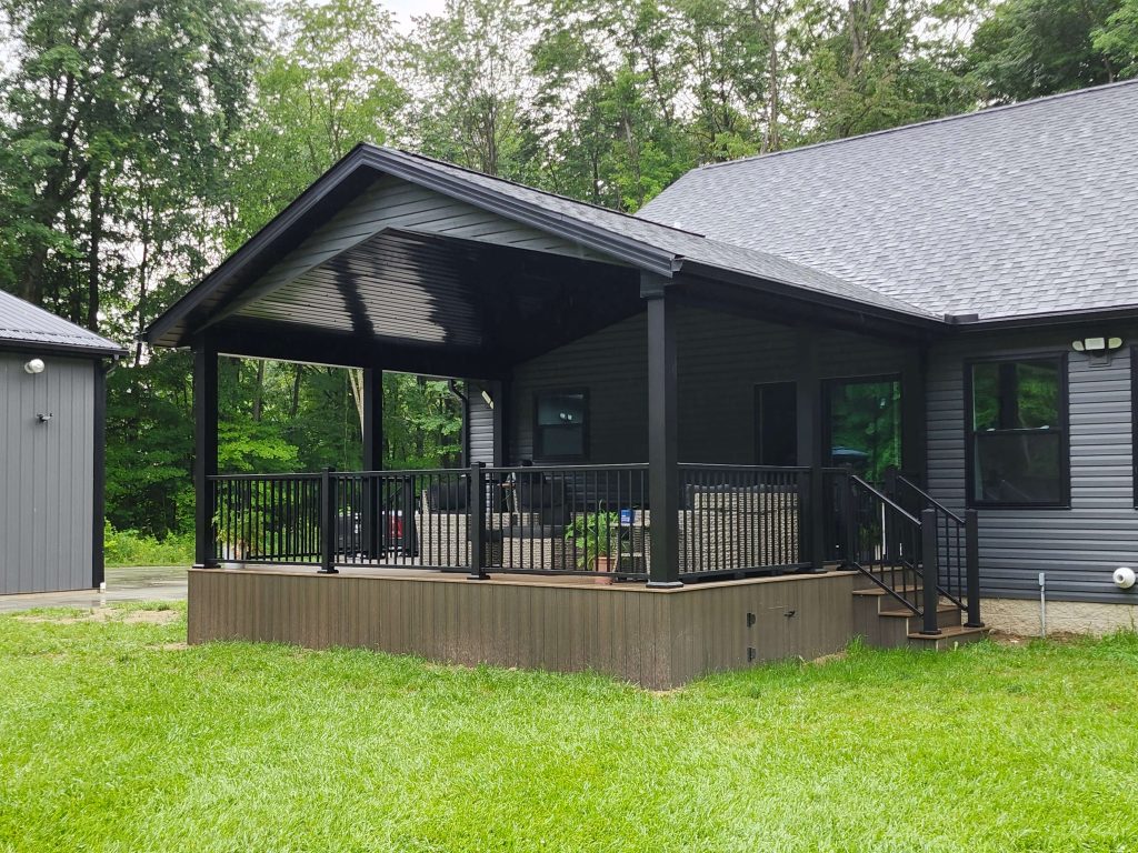 Side angle of raised covered porch with stairs and aluminum balusters constructed by D Miller Exteriors Apple Creek OH